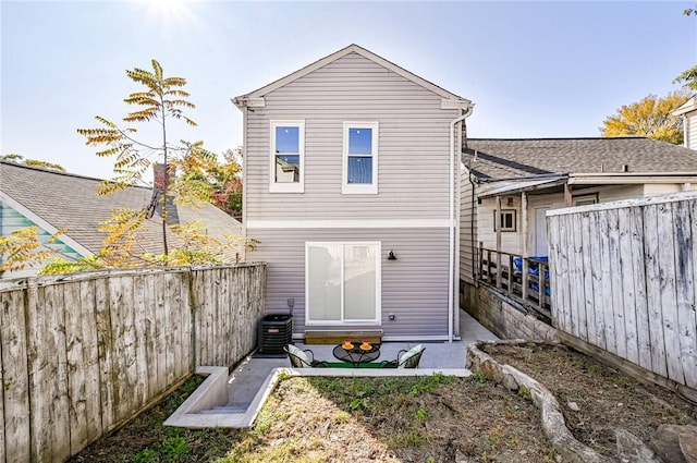 rear view of property with cooling unit