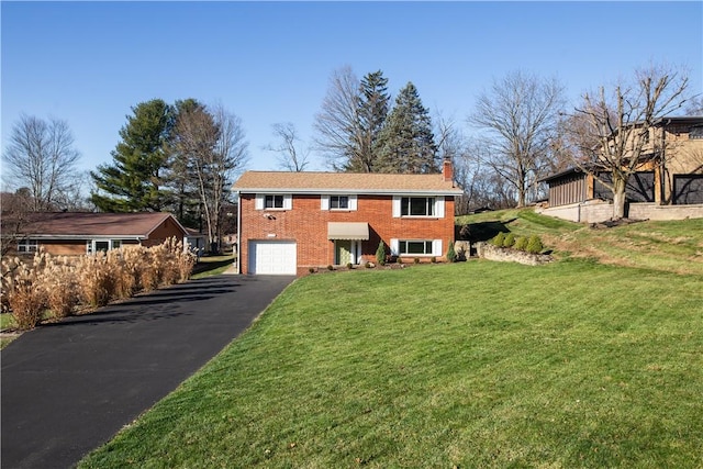 view of front facade with a front yard and a garage