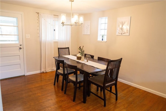 dining room featuring a notable chandelier and dark hardwood / wood-style flooring