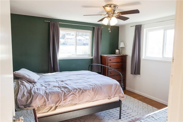 bedroom with wood-type flooring and ceiling fan