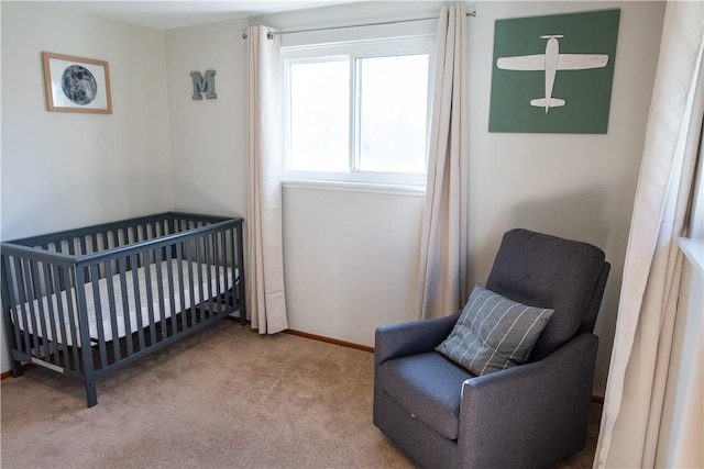 carpeted bedroom with a nursery area