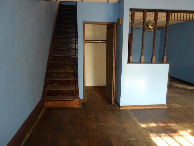 stairs with ceiling fan and wood-type flooring