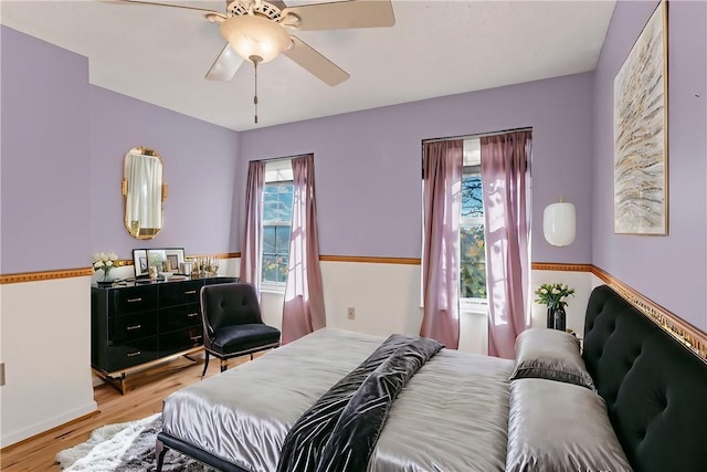 bedroom featuring ceiling fan and light hardwood / wood-style flooring