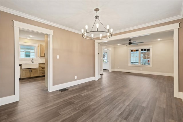 interior space with ceiling fan with notable chandelier, dark hardwood / wood-style flooring, ornamental molding, and sink