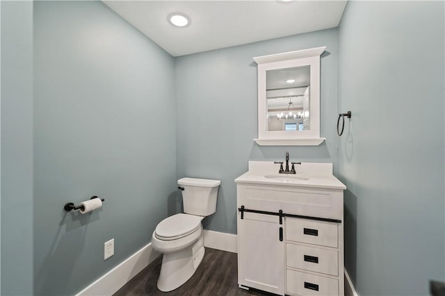 bathroom featuring hardwood / wood-style flooring, vanity, and toilet