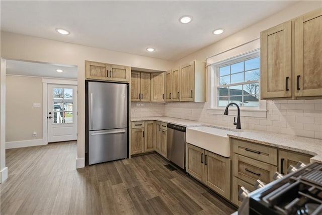 kitchen with sink, plenty of natural light, dark hardwood / wood-style flooring, and stainless steel appliances