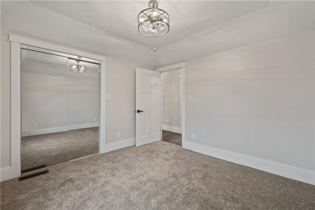 unfurnished bedroom with carpet flooring and a closet