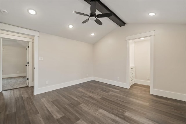 empty room with vaulted ceiling with beams, ceiling fan, and dark hardwood / wood-style flooring