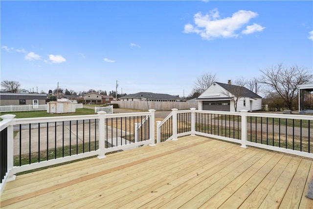 wooden terrace with an outbuilding and a garage