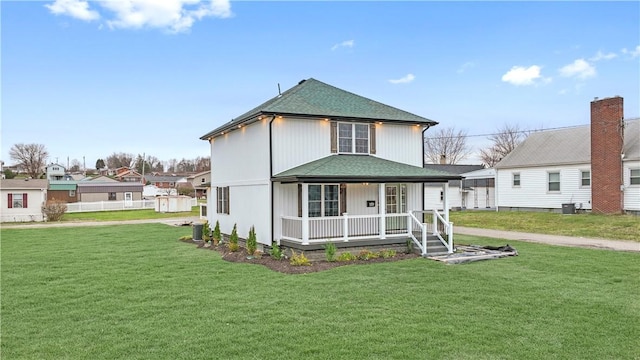 view of front of home featuring cooling unit, a front lawn, and a porch