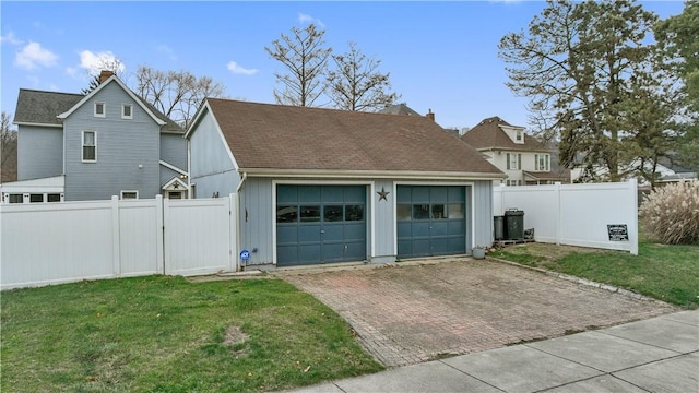 exterior space featuring an outbuilding, a garage, and a front lawn