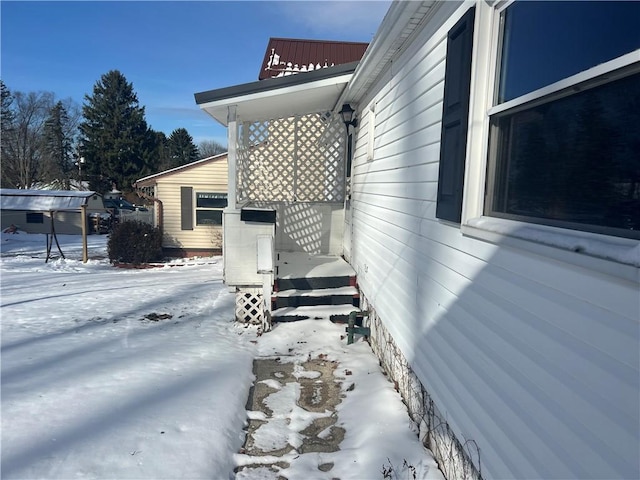 view of snowy exterior featuring metal roof