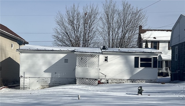 view of snow covered exterior featuring metal roof