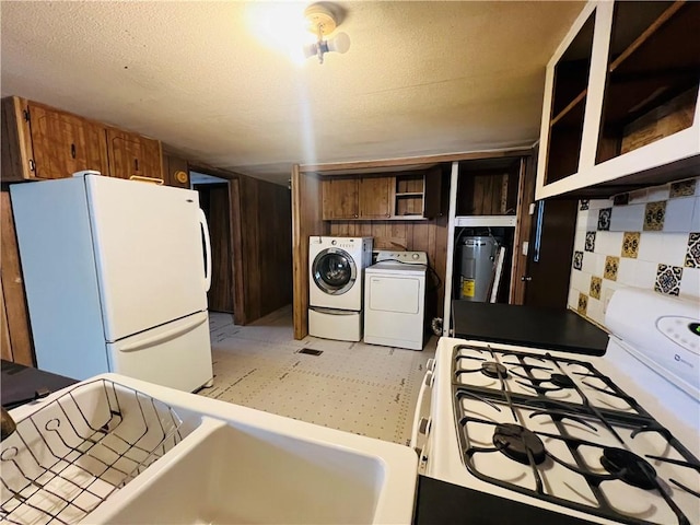 kitchen featuring washer and clothes dryer, brown cabinetry, white appliances, a textured ceiling, and open shelves