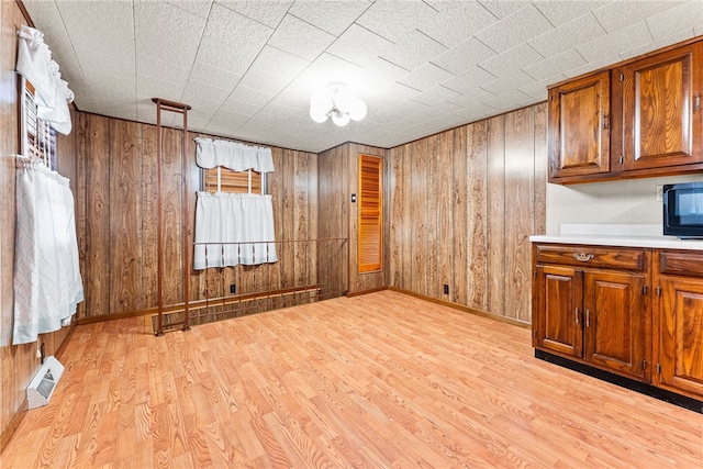 interior space featuring wood walls and light hardwood / wood-style flooring