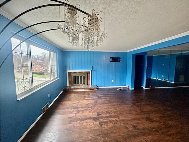 unfurnished living room featuring crown molding, hardwood / wood-style floors, and a textured ceiling