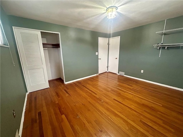 unfurnished bedroom with wood-type flooring