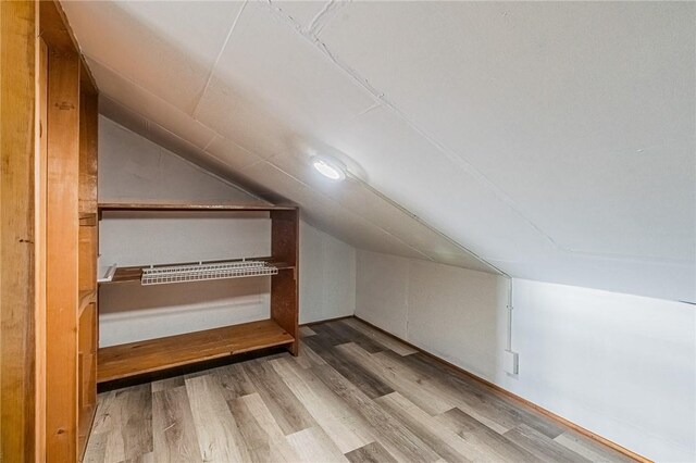 bonus room featuring light hardwood / wood-style floors and lofted ceiling