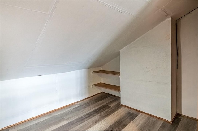 bonus room featuring lofted ceiling and hardwood / wood-style flooring