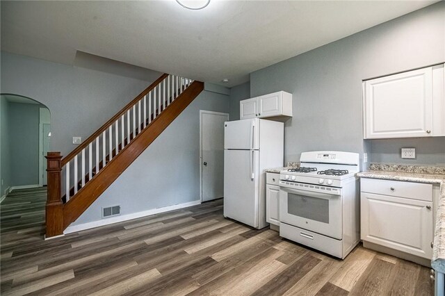 kitchen with white cabinetry, white appliances, and dark wood-type flooring