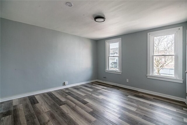 spare room featuring dark hardwood / wood-style flooring