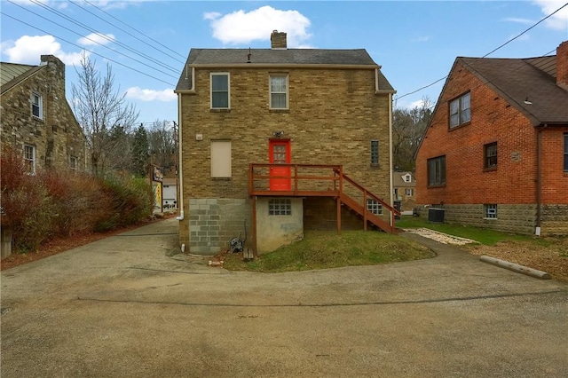 back of property featuring central AC unit