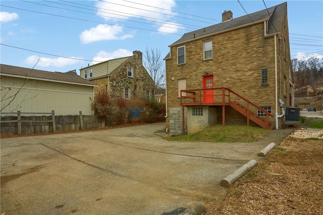 rear view of house featuring cooling unit