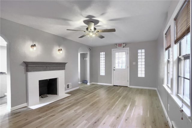 unfurnished living room featuring ceiling fan and light hardwood / wood-style flooring