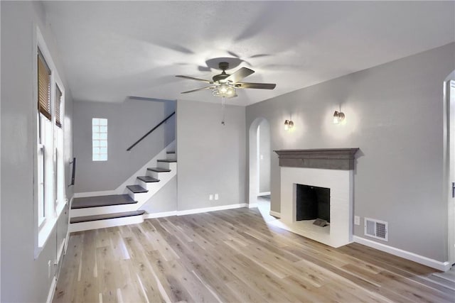 unfurnished living room with ceiling fan and light hardwood / wood-style floors