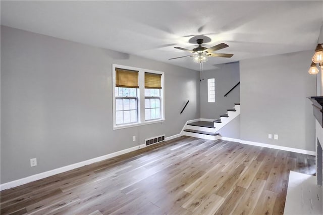 unfurnished living room with ceiling fan and light hardwood / wood-style flooring