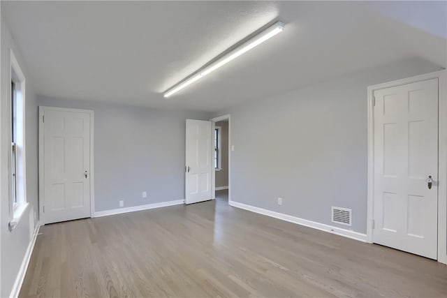 spare room with light wood-type flooring