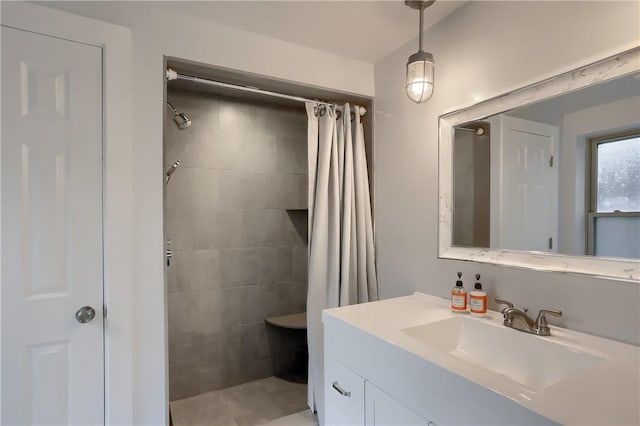 bathroom with tile patterned floors, vanity, and walk in shower