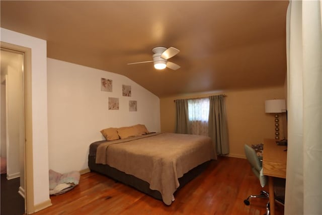 bedroom with ceiling fan, vaulted ceiling, and hardwood / wood-style flooring