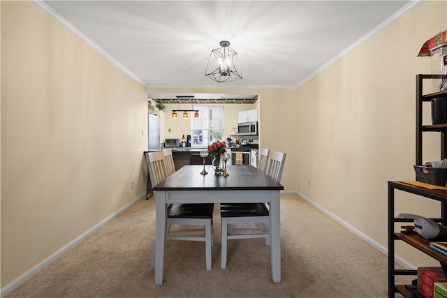 dining room with light carpet, ornamental molding, and a notable chandelier