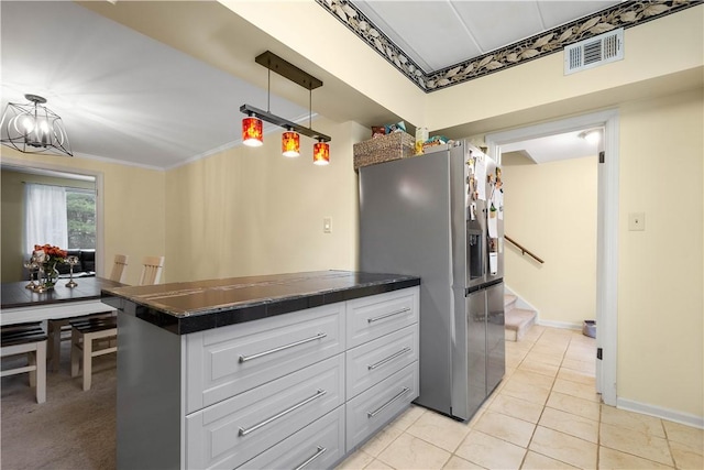 kitchen featuring white cabinets, crown molding, hanging light fixtures, light tile patterned floors, and stainless steel fridge with ice dispenser