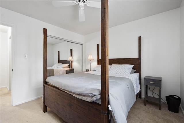 carpeted bedroom with ceiling fan and a closet