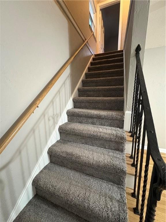 stairway with hardwood / wood-style flooring