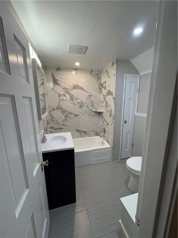 full bathroom featuring tub / shower combination, vanity, tile walls, tile patterned flooring, and toilet