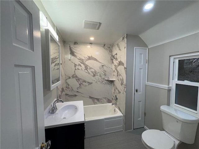 full bathroom featuring vanity, shower / bathtub combination, toilet, and vaulted ceiling