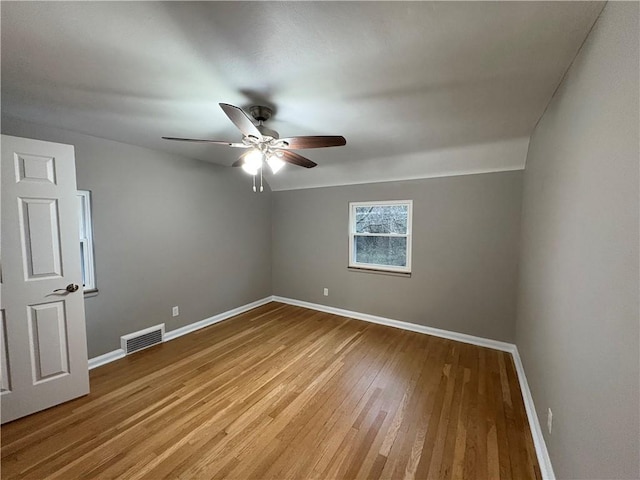 spare room featuring hardwood / wood-style flooring and ceiling fan