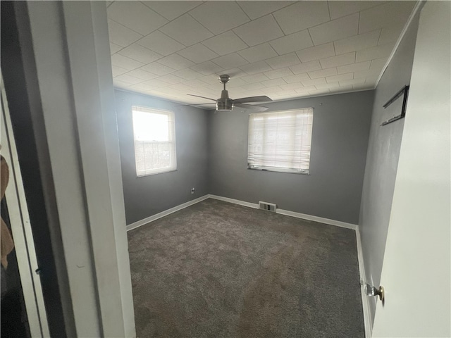 carpeted empty room featuring ceiling fan