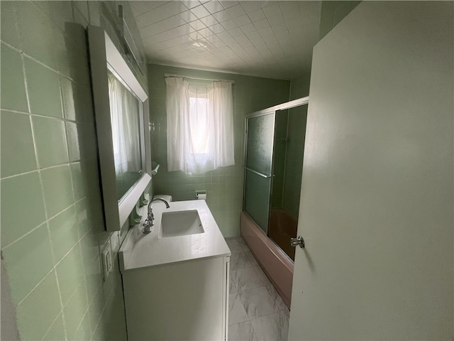 bathroom with shower / bath combination with glass door and vanity