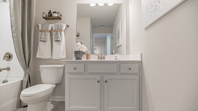 full bathroom featuring tile patterned flooring, vanity, toilet, and shower / bath combo with shower curtain