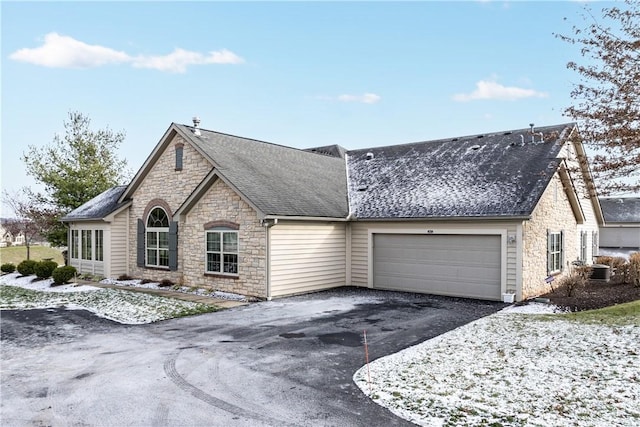 view of front facade with a garage and cooling unit