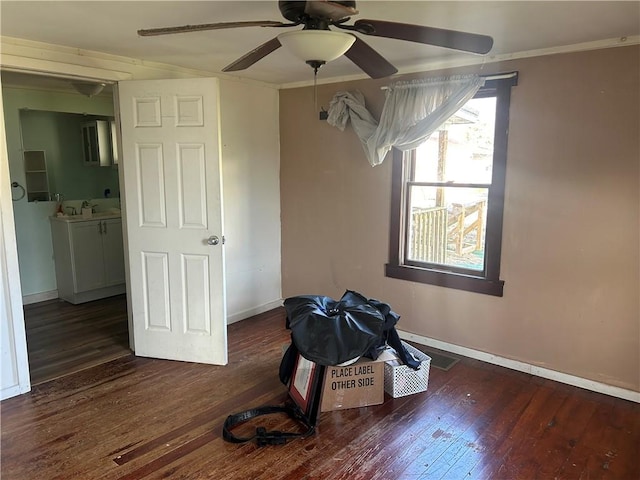 misc room featuring crown molding, ceiling fan, dark wood-type flooring, and sink