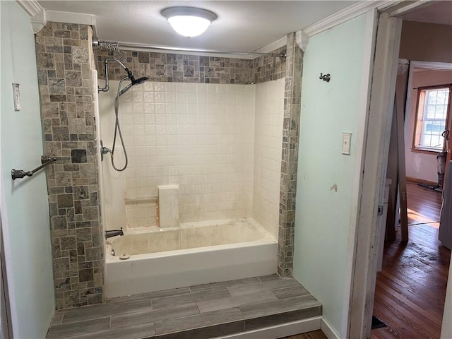 bathroom featuring tiled shower / bath combo and hardwood / wood-style flooring