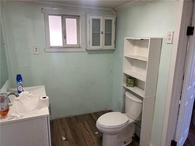 bathroom with hardwood / wood-style floors, vanity, toilet, and crown molding