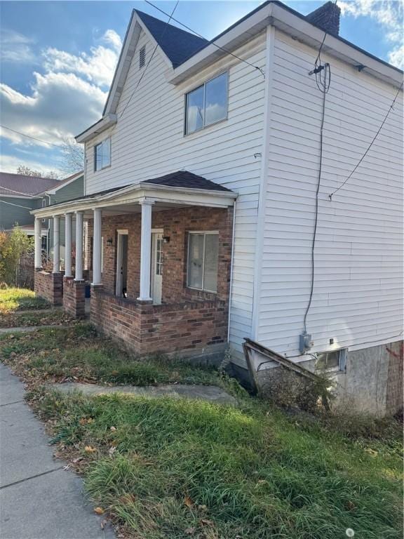 view of property exterior with a porch