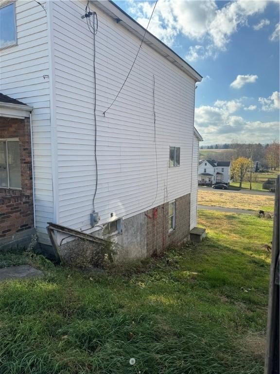 view of side of property with a lawn