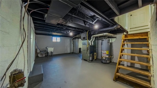 basement featuring heating unit, sink, and gas water heater